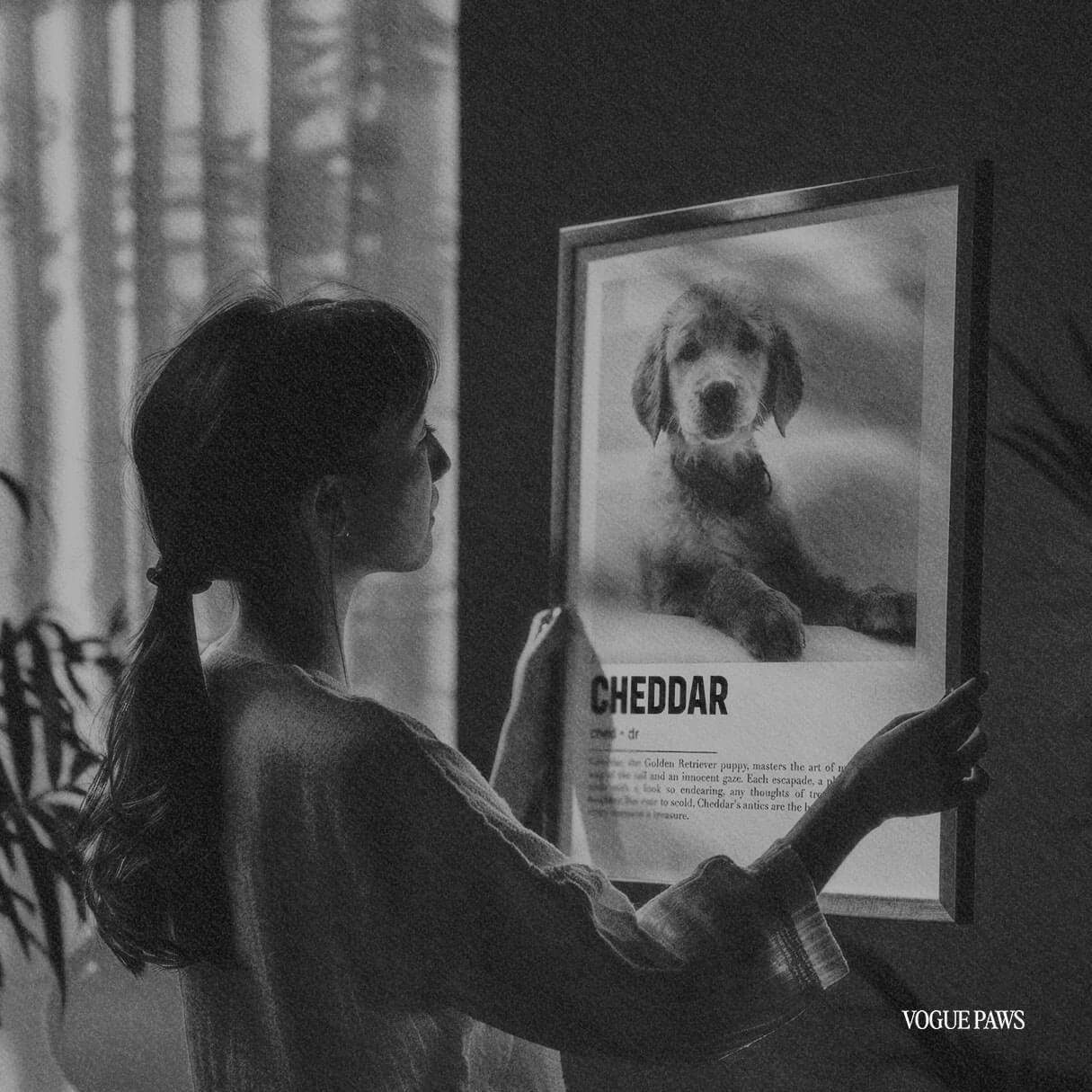 Black and white image of a woman holding a personalized pet portrait dog mom gift, made from pet photos to create unique dog portrait gift ideas for dog moms.